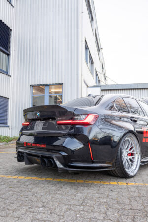 Schwarzes Auto vor Gebäude geparkt.